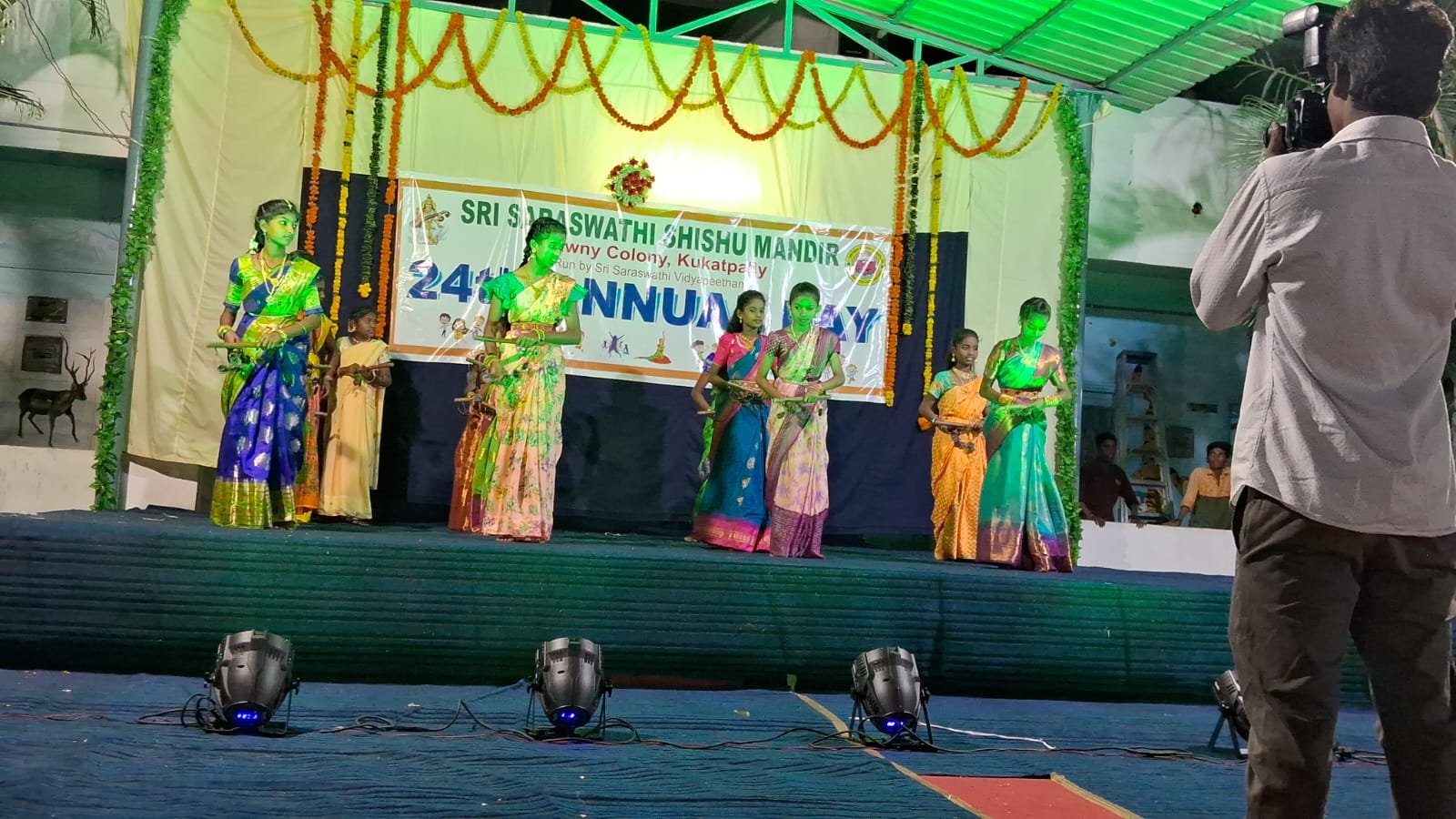Students performing on a decorated stage at annual day