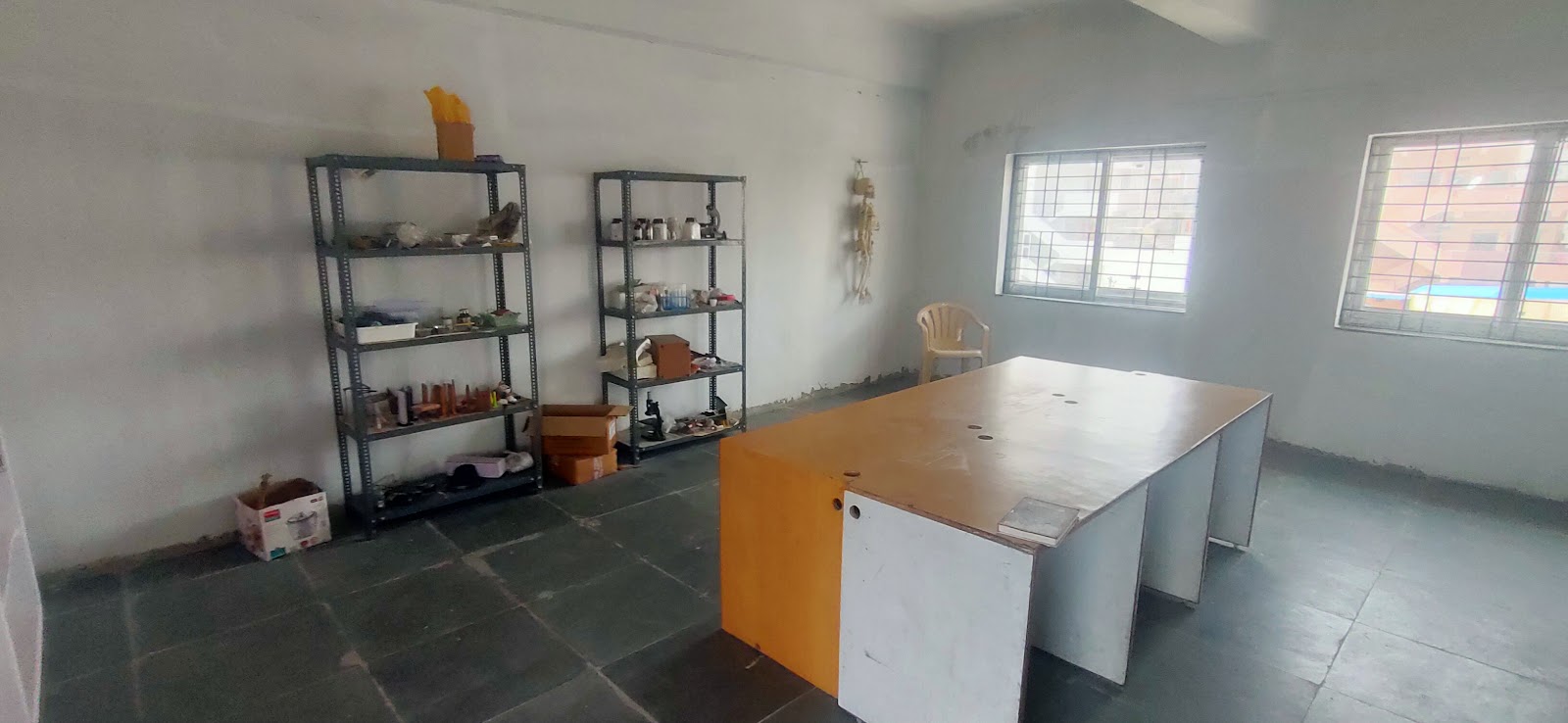A classroom with tables, shelves and learning materials