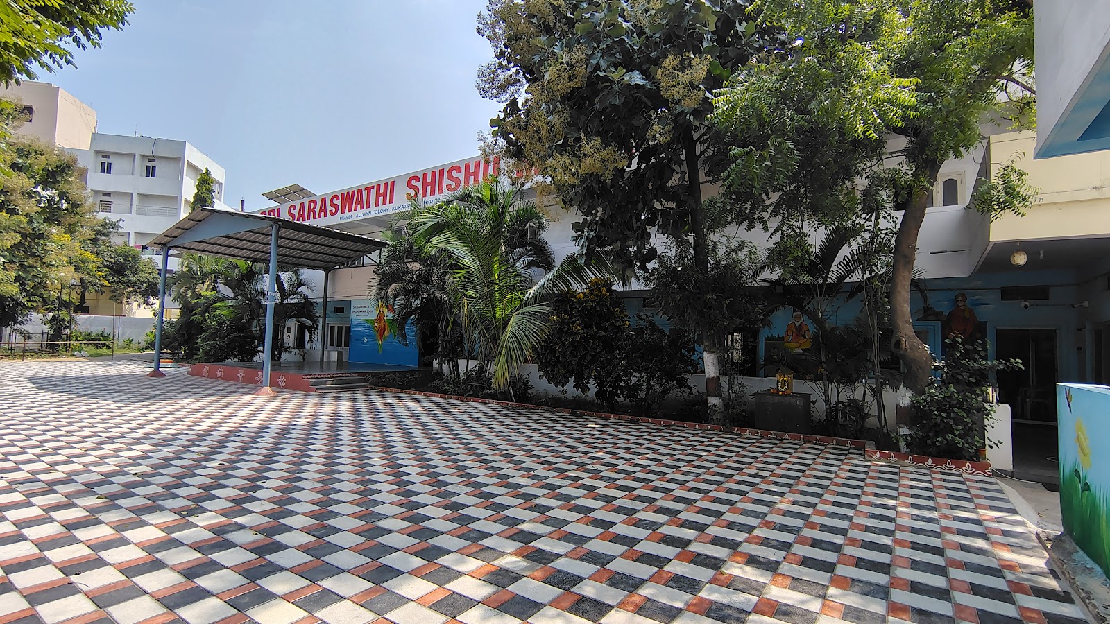 Tiled school courtyard with trees and campus buildings
