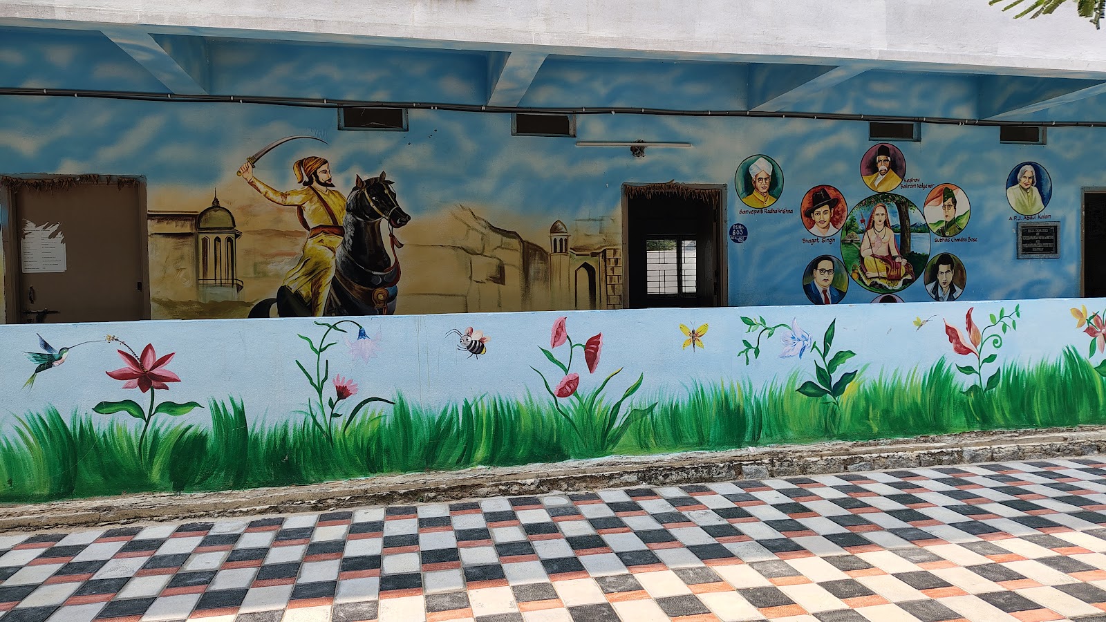 Colorful educational murals along a school wall